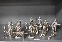 A collection of silver plated metal cast figures of a musical band.