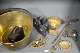 A selection of fireside items including two stove irons and a large brass jam pan.