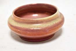 An early 20th century Royal Lancastrian pottery bowl having a red ground and yellow lustre glaze,