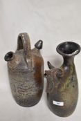 Two mid century studio pottery pieces including a vase with bull head decoration and a olive oil jug