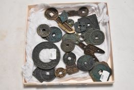 A selection of replica Chinese cash coins and tokens in cast metals.