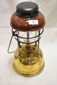 A 20th century paraffin gas lamp having brass base with enamel top plate.