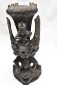 An early 20th century Indonesian Bali wooden carved totem figure of Vishnu riding Garuda Naga Pita