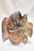 A 20th century terracotta Chinese styled Koi carp animal study painted in reds, 30cm tall.