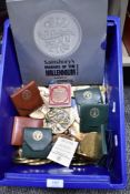 A collection of souvenir coins medallions and plaques, most in cast metals and bronze.