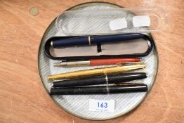 Four fountain pens and one ball point including Schaeffer, Osmiroid and Parker.