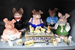 Five Wade Natwest piggy banks with a selection of Wade Whimsies.