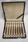 A cased set of Japanese Samurai steak knives in steel and wooden handles.