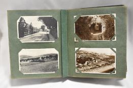 An early 20th century postcard album complete, having black and white photo cards or local and world