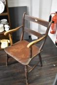 A Victorian carver chair having painted frame with elm seat and beech frame with ladder back.
