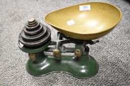 A set of early 20th century kitchen weighing scales with a set of cast weights.