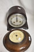 An early 20th century bakelite Smiths mantel clock with a button form barometer.