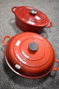 Two modern red enamel lidded Caserole dishes. In the style of Le Creuset.