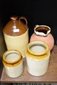Two earthen ware storage jars with a damaged jug and a terracotta jug.