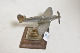 A small model of an RAF Spitfire aeroplane cast in copper and chromed, stamped to base 1945 GHC