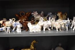 Approximately twenty modern cow creamers in various designs and styles.