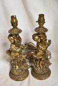 A pair of vintage metal cast and brass effect cherub form lamp bases.