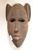 An early 20th century African tribal ritual mask having painted polychrome decoration with