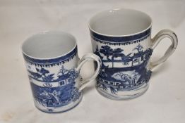Two large 19th century Chinese export porcelain mugs both hand decorated with landscape scenes and