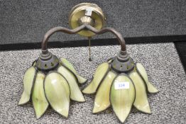 A modern wall mounted light with double branch in the form of a lily with coloured leaded light