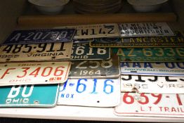 Fifteen American vehicle license plates.
