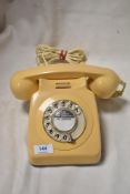 A vintage GPO telephone set in a light peach colour.