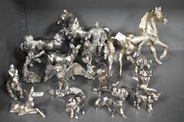 A collection of cast metal animal studies including horses birds and rabbits.