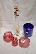 Three pieces of early 20th century cranberry glass with enamel decorated floral designs, a Heron