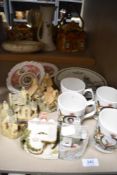 A selection of souvenir wares and four Lilliput lane model houses