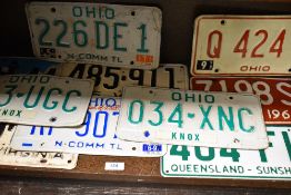 Ten 20th century American vehicle license plates.