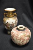 Two early 20th century Japanese Satsuma vases. One of squat ball form decorated with cherry