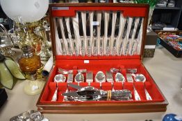 A vintage Viners Teak canteen of cutlery with some similar Viners cutlery of a similar design.