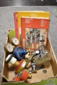 A box of automobilia including a Rozalex chromed soap dispenser, two gauges and three Ford books