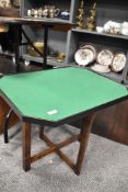 A small fold out table with green felt Baize top.