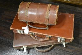 Two leather briefcases with a leather green bowls case.