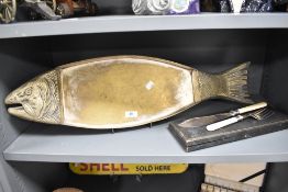 An early 20th century brass fish serving tray in the form of a salmon with a serving cutlery set.