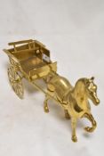 A vintage brass model of a horse and cart.