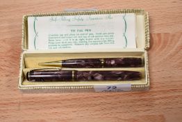 A boxed Burnham 49 lever fill fountain pen and propelling pencil set in purple marble. Pencil AF
