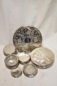 A good selection of silver plated table mats and coasters including a bird set by King.