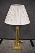 A vintage brass lamp base in the form of a classical column 50cm tall excluding shade.