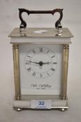 A modern WM. Widdop carriage style clock in a silver plate effect case.
