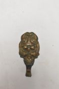A Chinese Ruyi Scepter or buckle fastener in the form of a central dragon form hook surrounded by