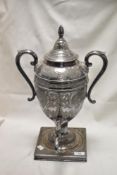 A Victorian silver plated samovar tea urn having floral chase worked decoration with twin handles