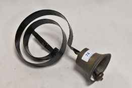 A late Victorian shop door bell in brass with coil spring.