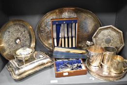 A selection of silver plated serving wares including gallery trays, cutlery and tankards.