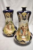 A pair of early 20th century mantel vases with transfer printed designs of historic couples