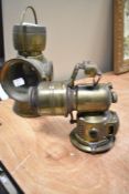 Two early 20th century carbide cycle or motor lamps including King of the Road no. 652 and P&H.