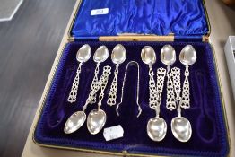 Four HM silver tea spoons having pierced handle decoration with six similar spoons and a pair of