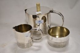 An Art Deco silver plated tea set including teapot, sugar bowl and creamer.