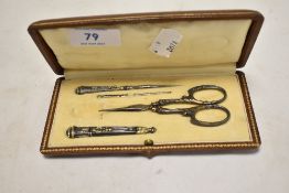 A Victorian sewing kit including scissors, bodkin needle case and piercing needle.